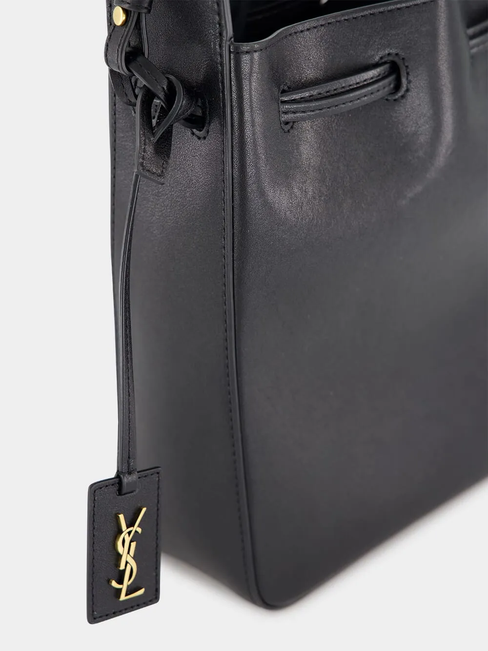 Black Leather Bucket Bag with Cassandre Charm